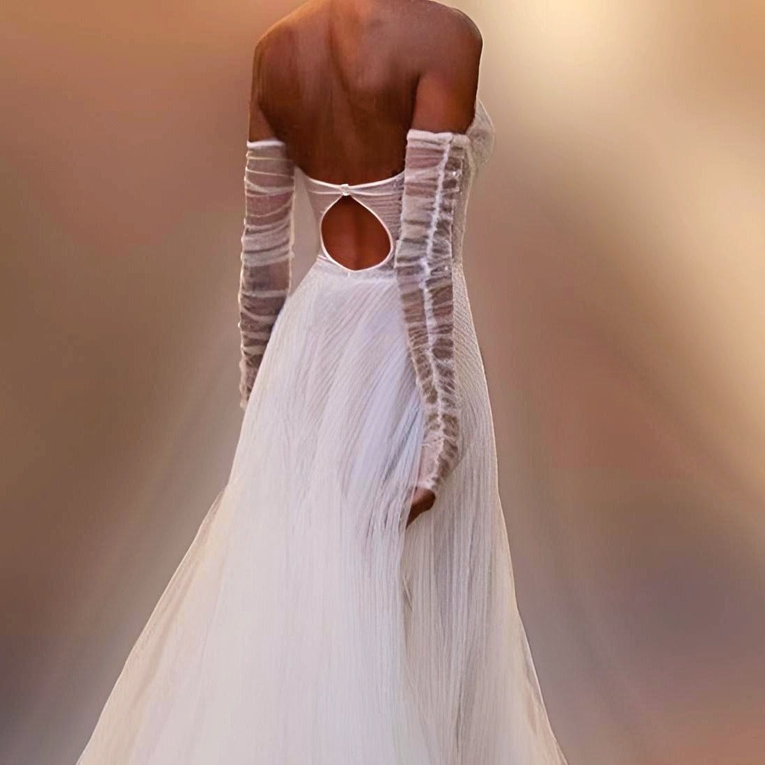 Bride wearing sheer ruched bridal sleeves with a ruched design.