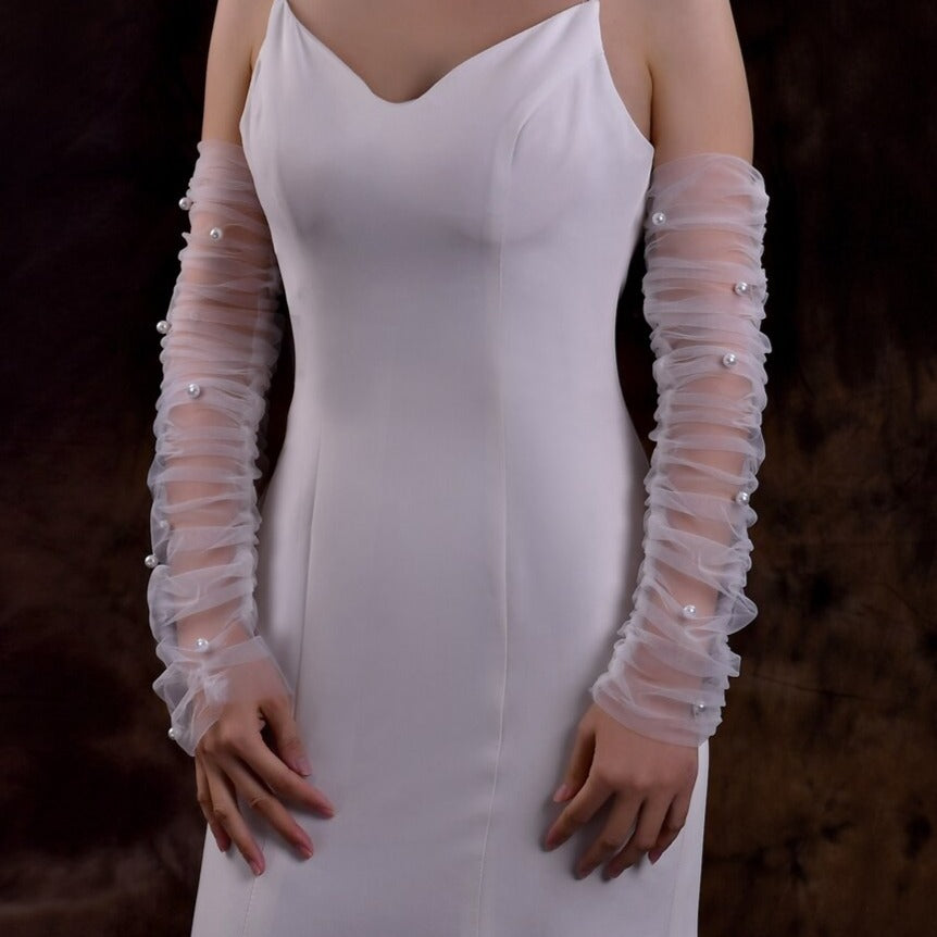 Bridal gown with ruched detachable sleeves adorned with pearls