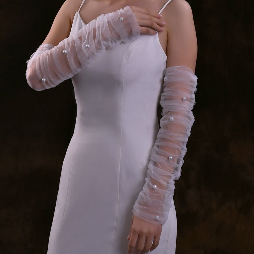 Woman styling her dress with glittery wedding sleeves