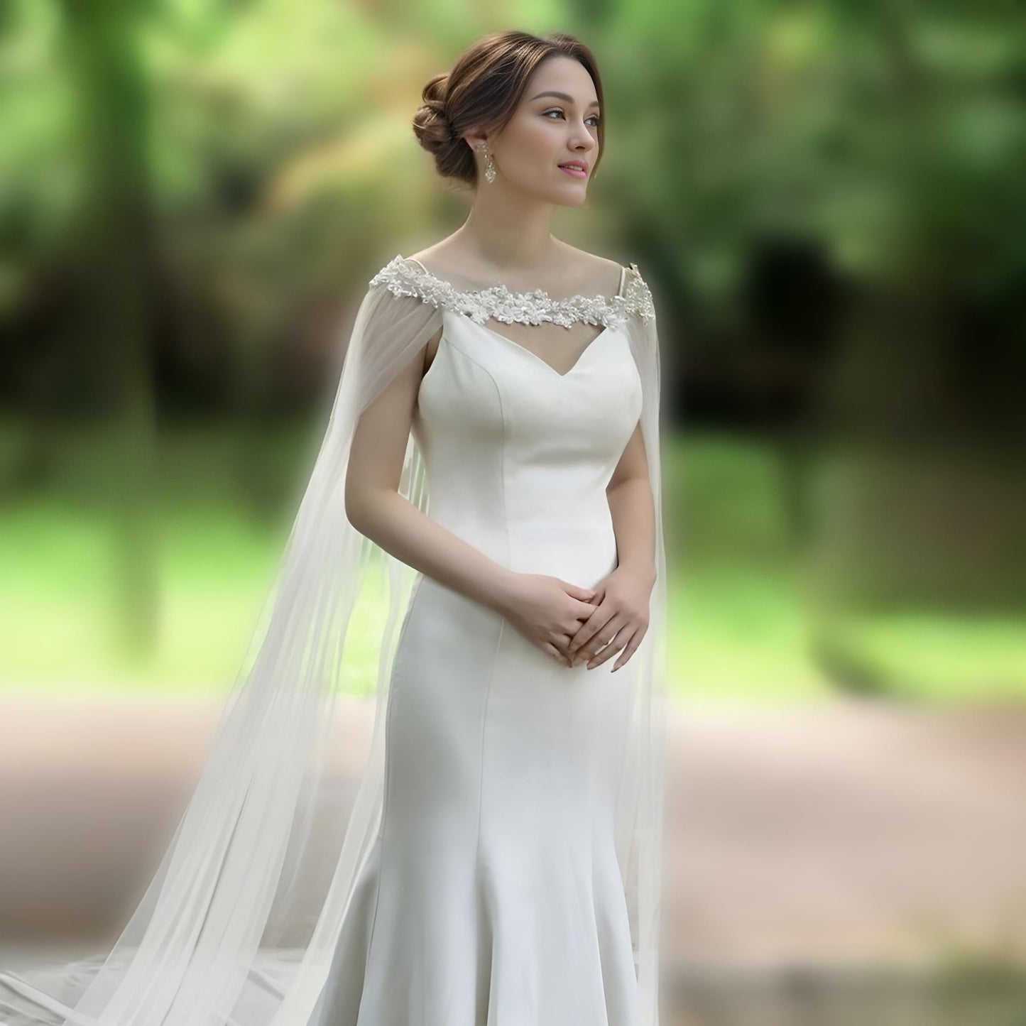 Bride wearing rhinestone beaded wedding cape with 3-meter cathedral veil.