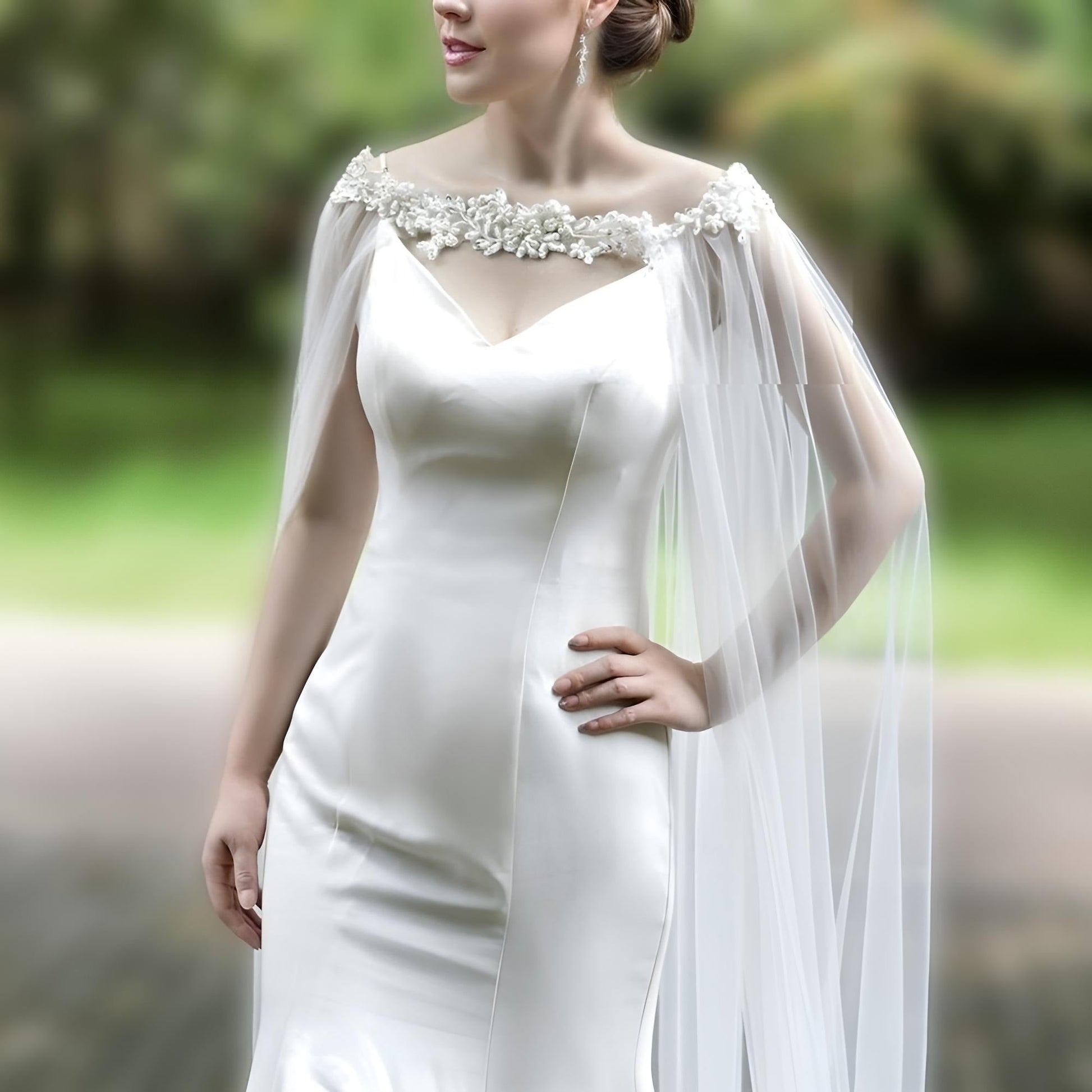Bride showcasing long flowing cathedral veil with rhinestone accents