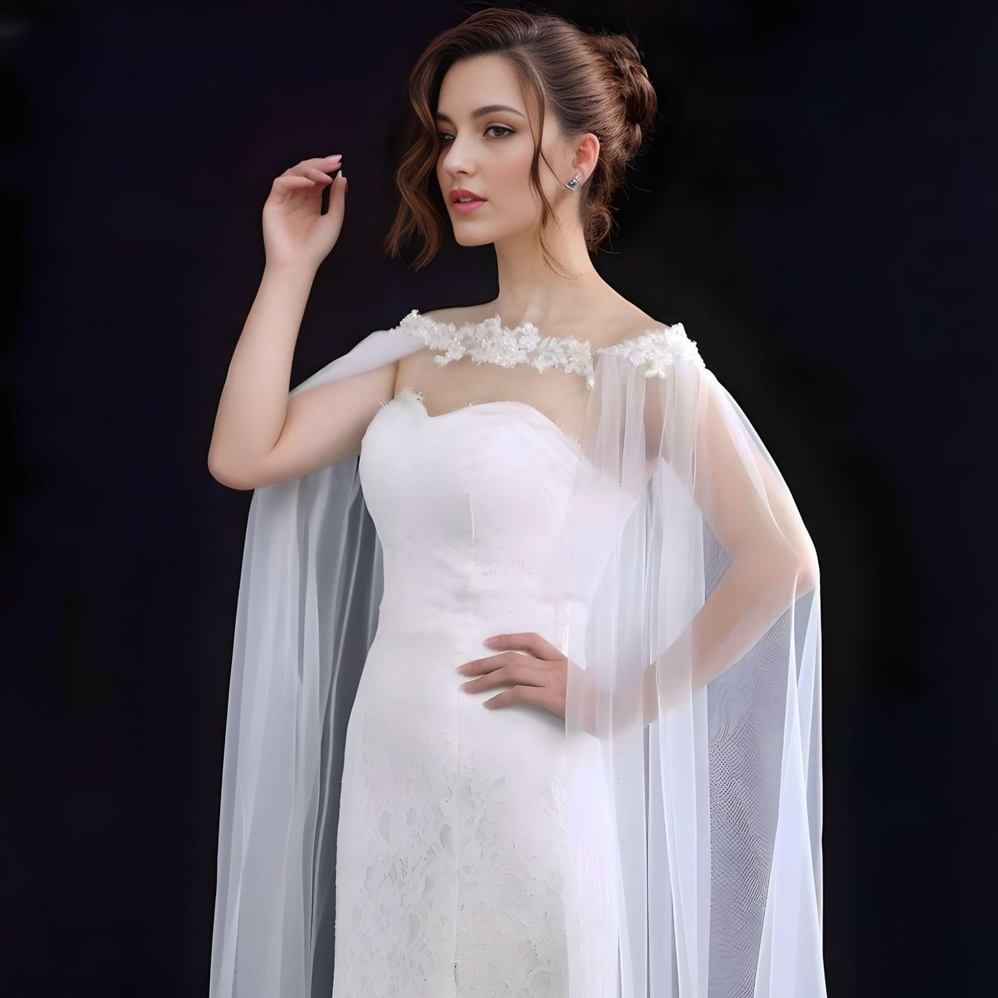 Bride showcasing long flowing cathedral veil with rhinestone accents.