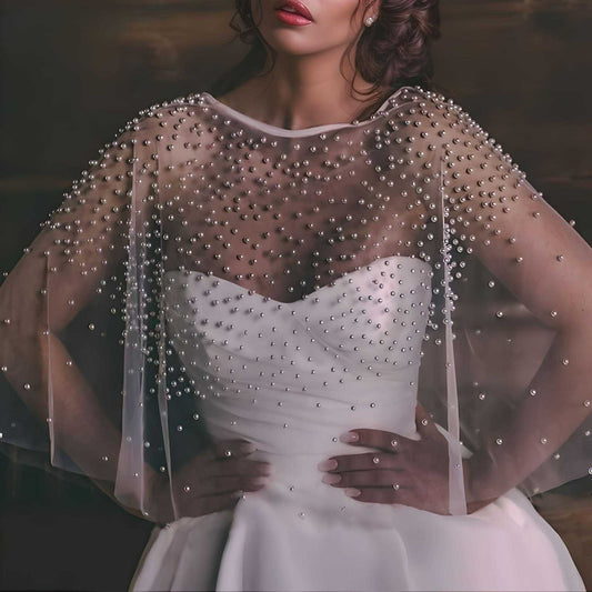 Bride wearing pearl-beaded bridal wrap bolero cape over wedding dress.