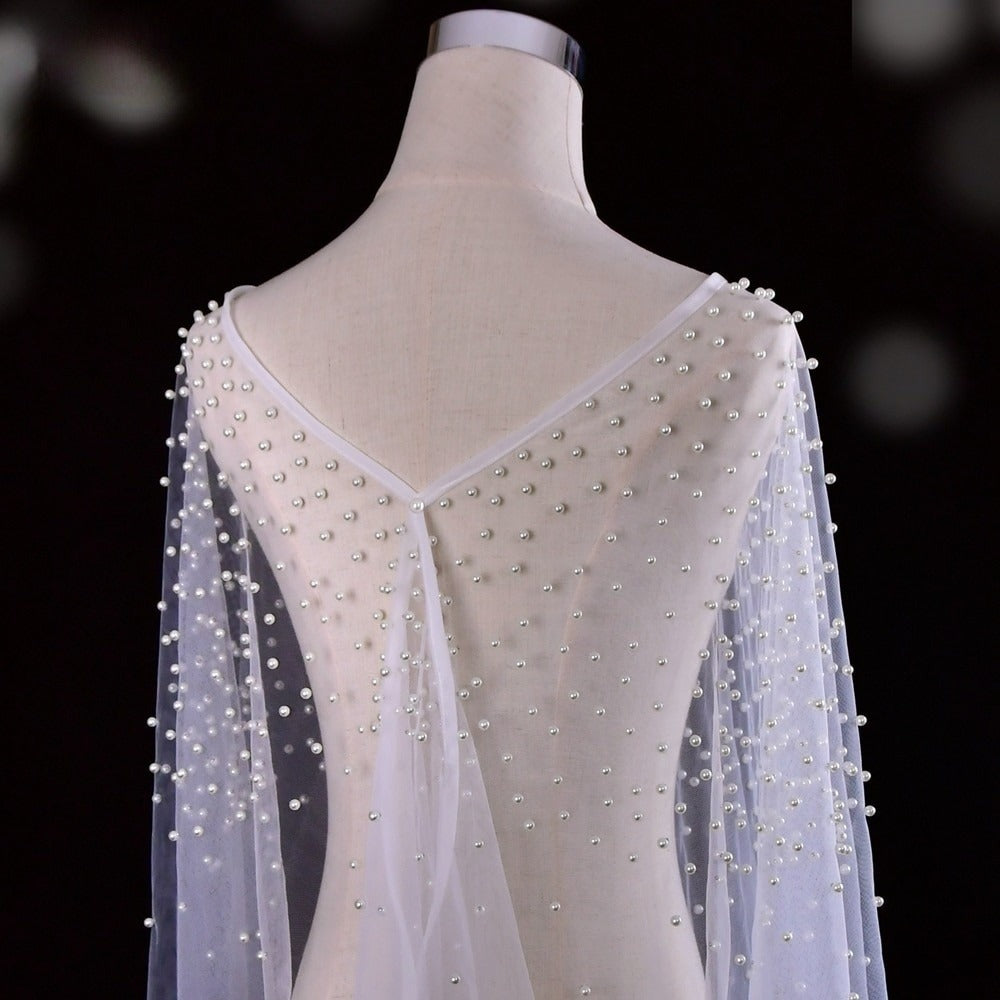 Back view of flowing pearl-beaded bridal wrap cape.