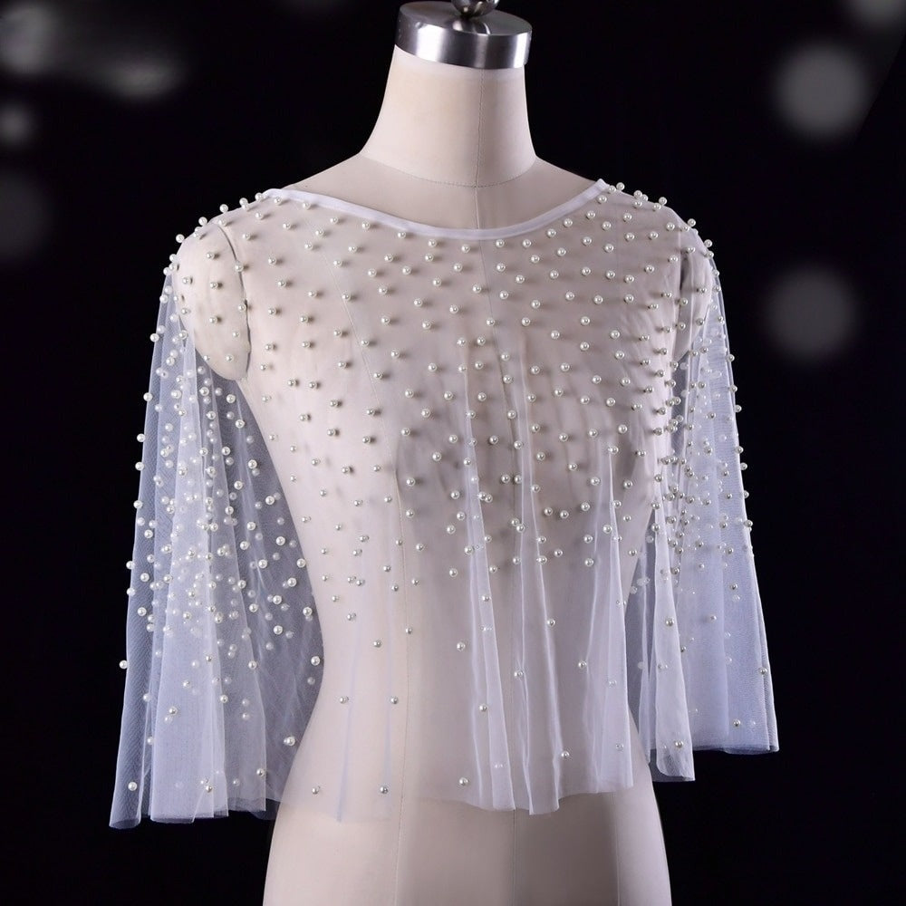 Elegant bride in bolero wrap cape on tailor mannequin.