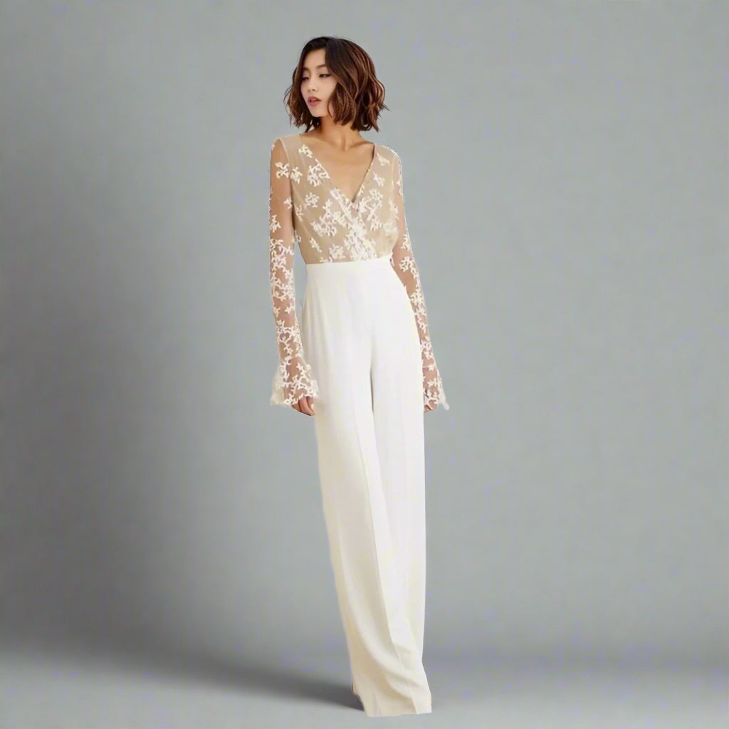 Bride wearing RYAN wedding jumpsuit with lace illusion back and long sleeves.