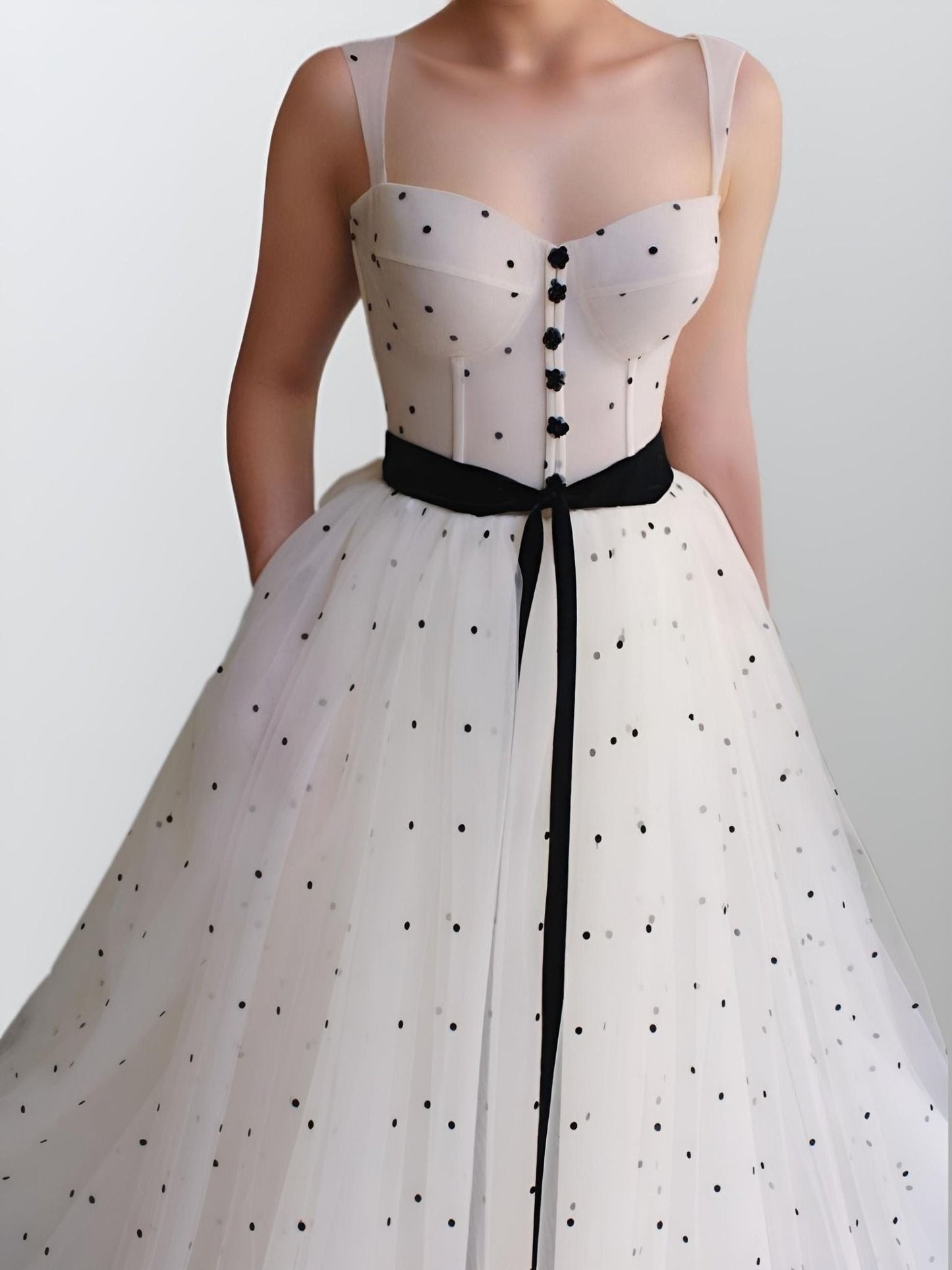 CLose up front view of Sanai formal dress with sweep train and pockets.