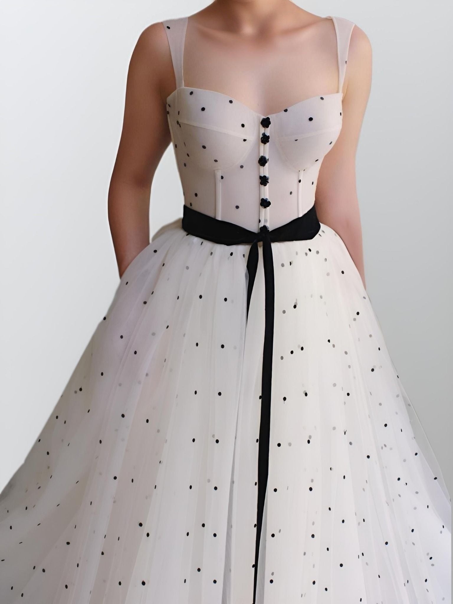 CLose up front view of Sanai formal dress with sweep train and pockets.