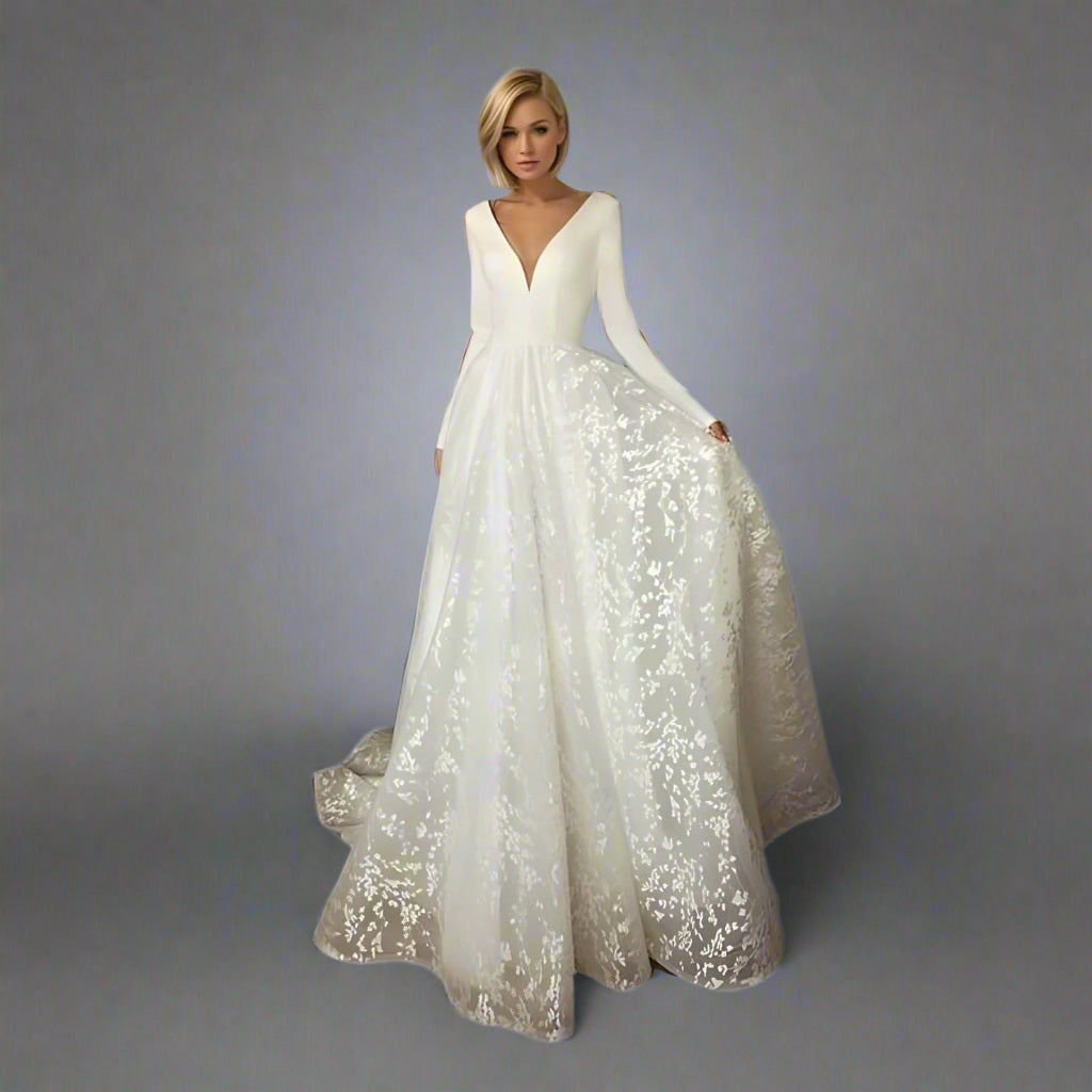 Bride wearing SARAH wedding dress with long sleeves and V-neckline.