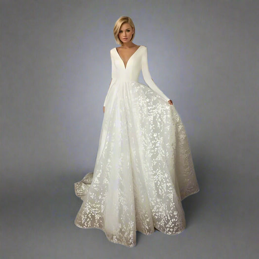 Bride wearing SARAH wedding dress with long sleeves and V-neckline.