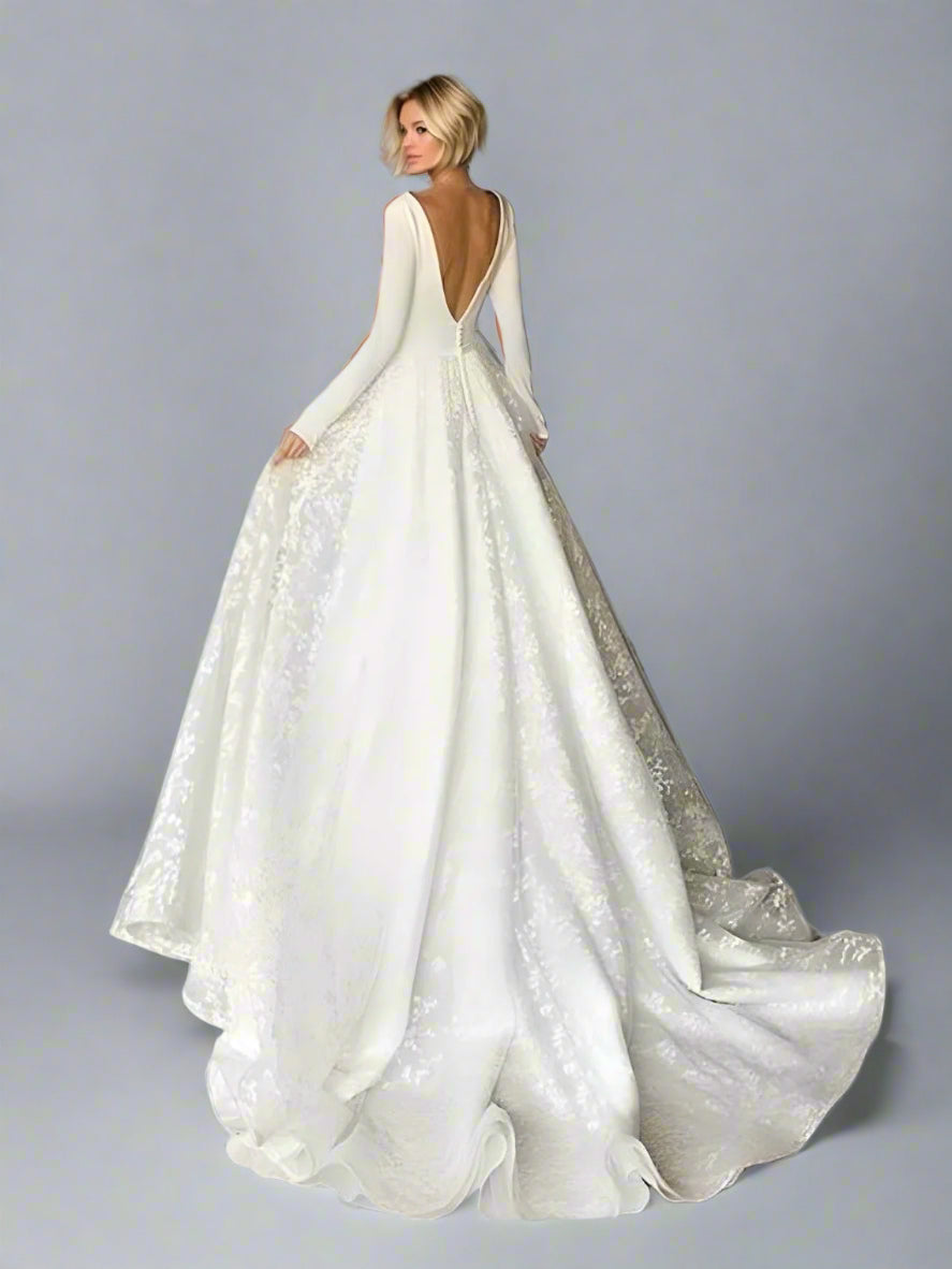Full backview of bride in SARAH A-line wedding gown with button back and low back.