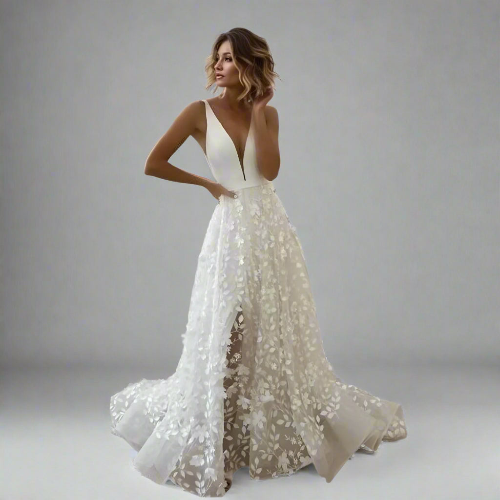 Bride wearing SARAI satin A-line wedding dress with deep V-neck and spaghetti straps.
