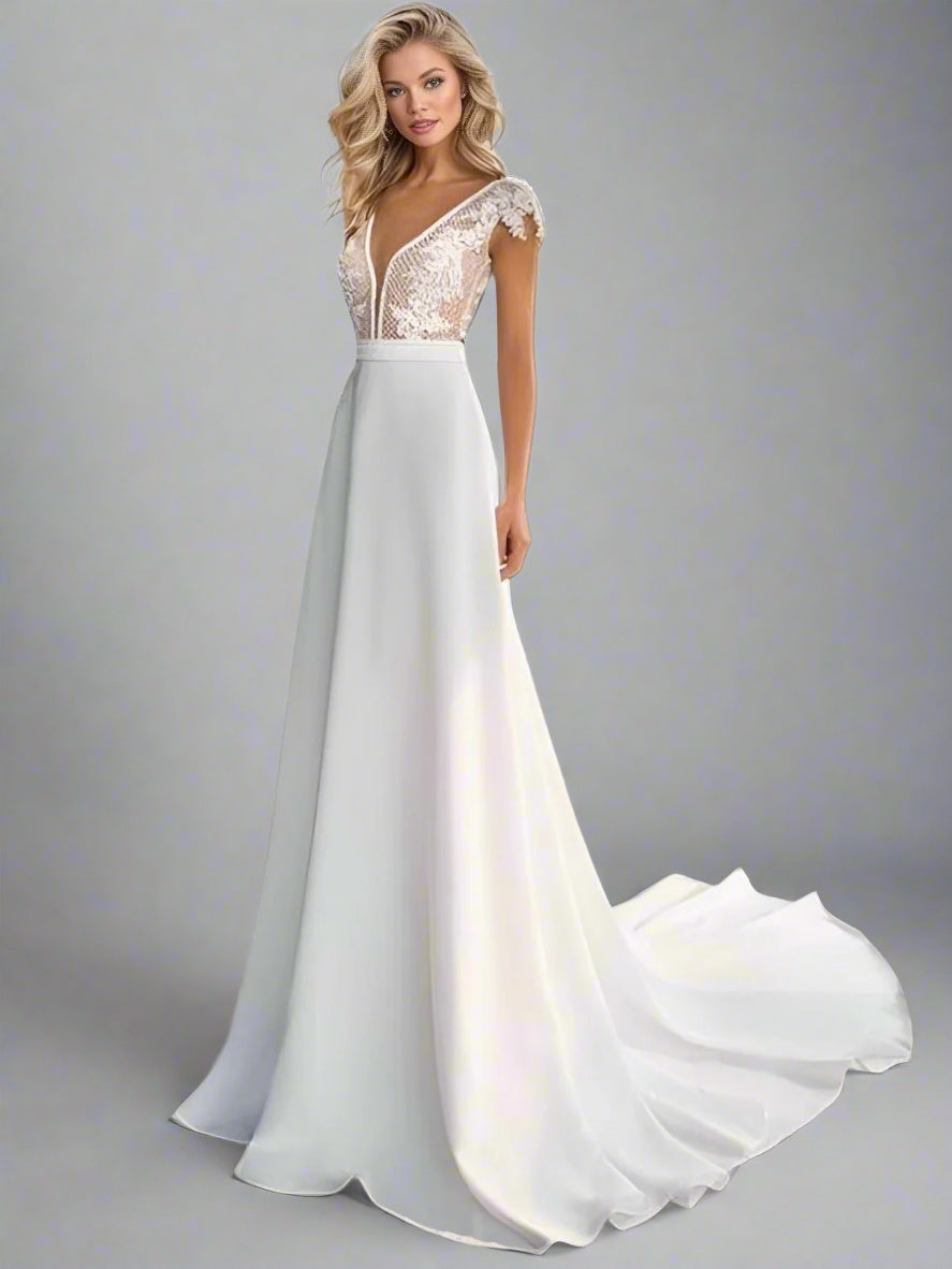 Bride posing in the Selenia Wedding Dress with soft natural makeup and minimal accessories.