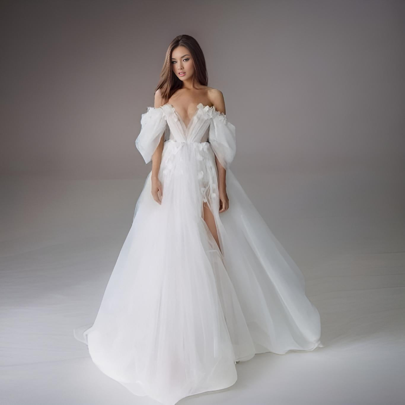 Bride wearing the SHERYL wedding dress with a deep V-neck, glitter tulle and high slit.