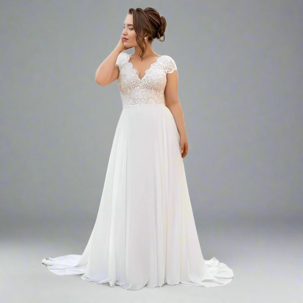 Plus size brunette bride wearing the SKYE Wedding Dress, showcasing the lace bodice and chiffon skirt.