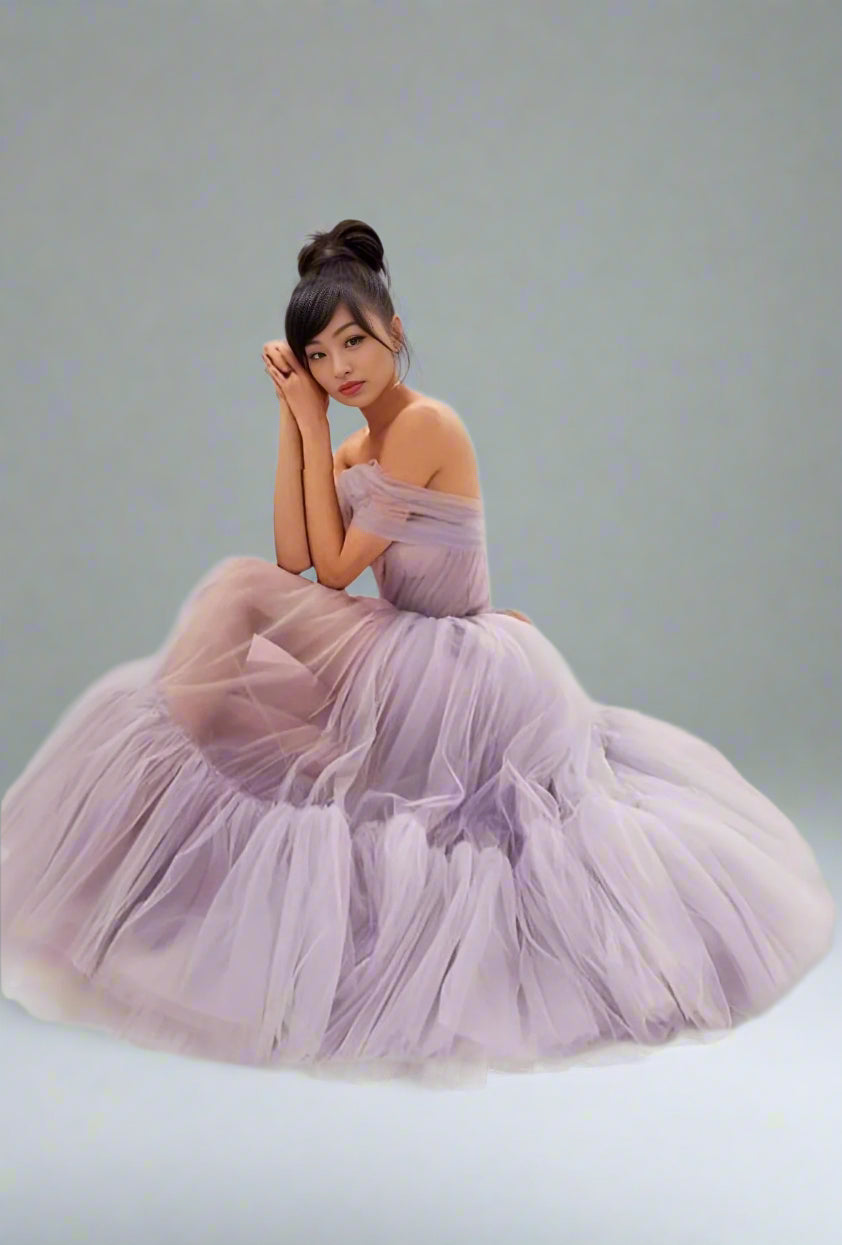 Model sitting in light purple the SKYLAR formal prom dress, emphasizing fluffy tulle skirt.