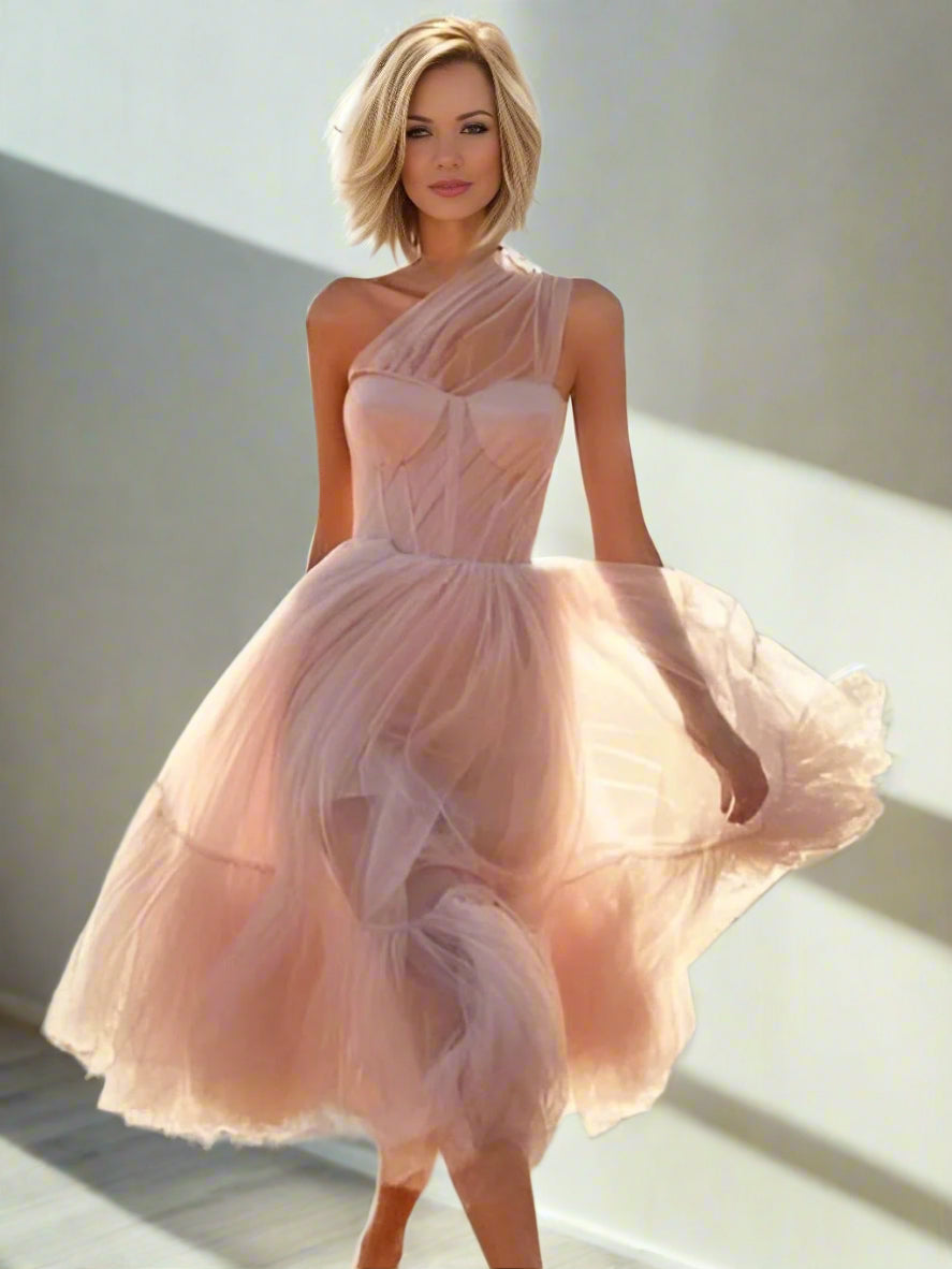Model wearing light pink Skylar Formal Dress, showcasing the asymmetrical style and elegant pleats.