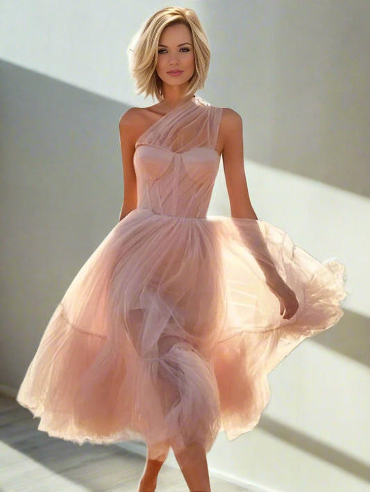 Model wearing light pink Skylar Formal Dress, showcasing the asymmetrical style and elegant pleats.