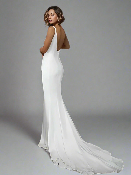 Woman in bridal gown featuring a backless design and train