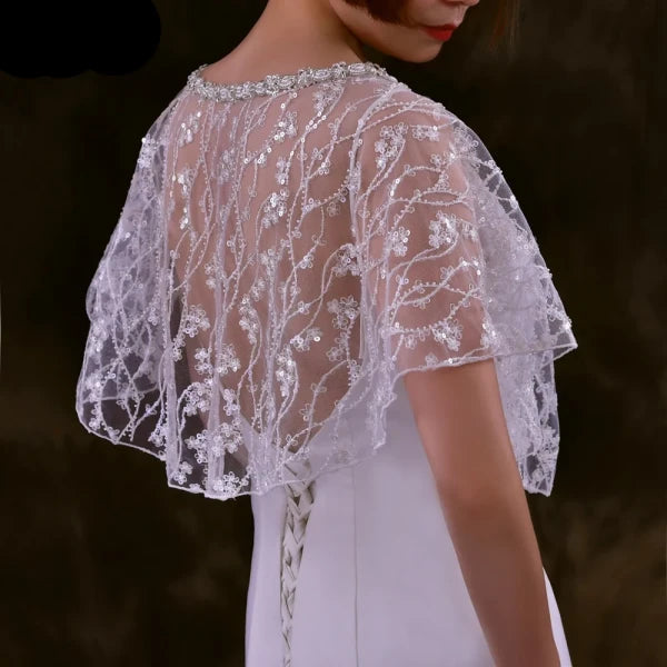 Side view of the bride wearing the Sparkling Beaded Wedding Bolero with the gown's train flowing beneath.