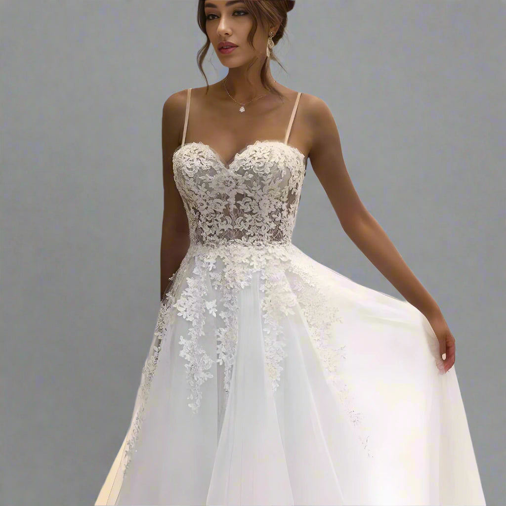 Bride wearing the Stephanie Wedding Dress, showcasing the lace bodice and flowing tulle skirt.