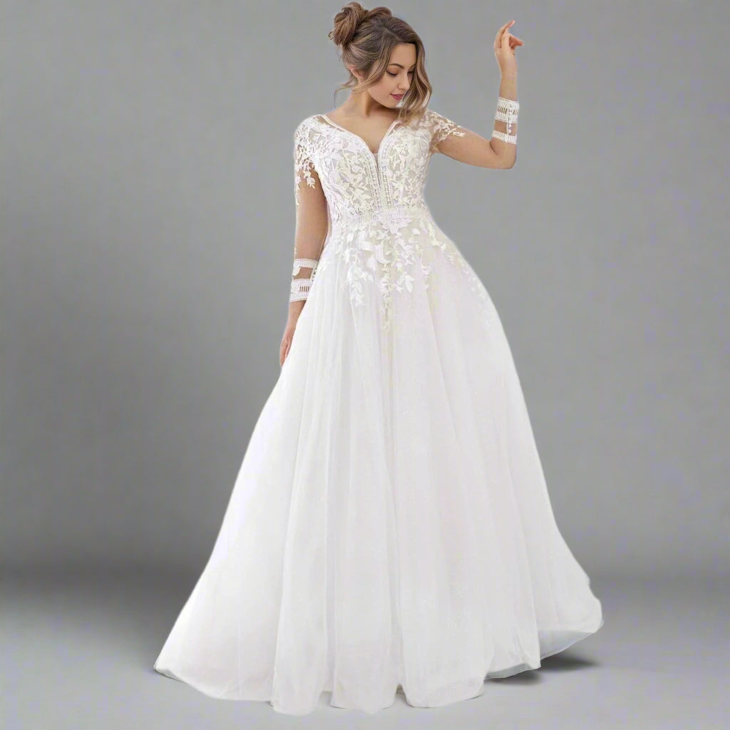 Curvy bride wearing the Tania Plus Size Wedding Dress, showcasing the lace bodice and flowing tulle skirt.