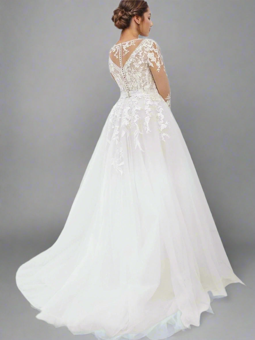 Back view of the bridal gown, displaying the elegant buttons and lace back illusion.