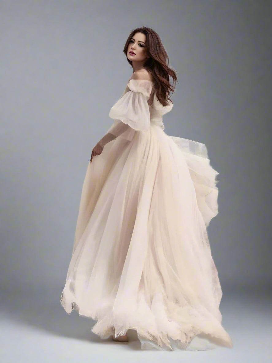 Side view of bride highlighting flowing skirt and and ruched details
