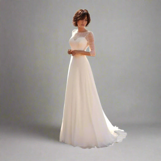 Elegant bride in Tori wedding gown with lace top and three-quarter sleeves