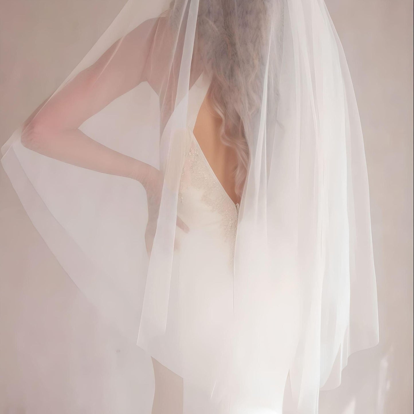 Bride wearing timeless two-layer wedding veil in ivory with soft finish