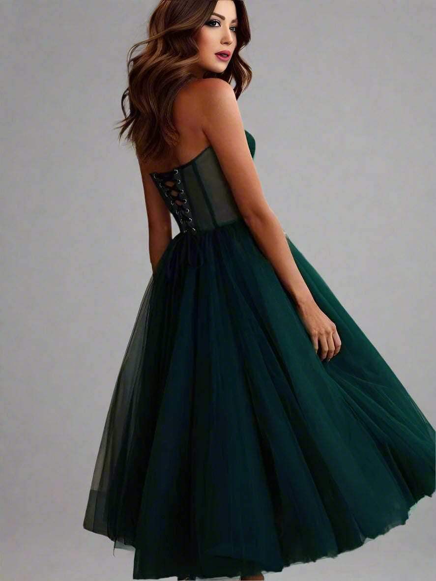Woman from back in the emarald green Vanessa Formal Dress showing the lace up back.