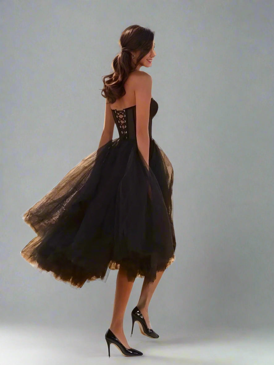 Woman in Vanessa dress in motion, highlighting the back design and flowy tulle fabric.