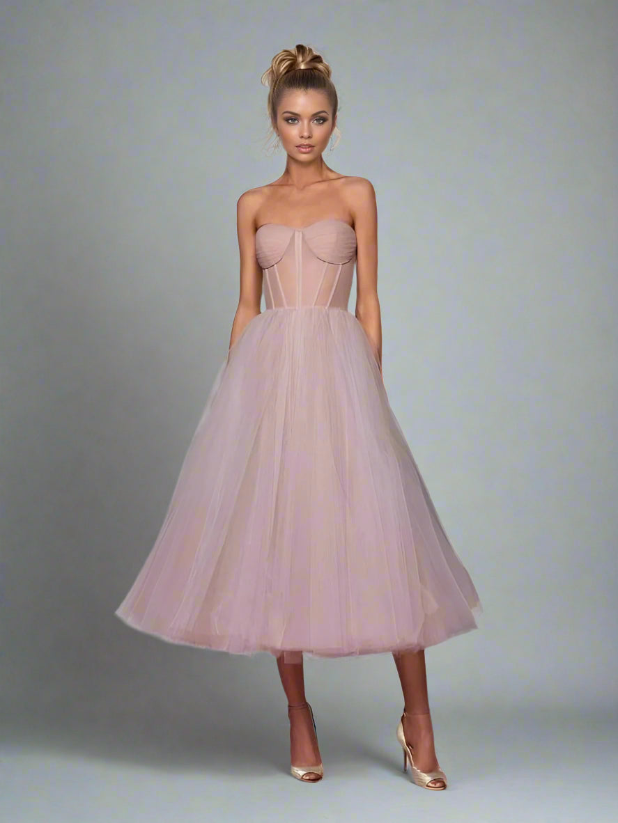 Blond woman in prom dress with elegant pleated bodice with sheer structured boning.