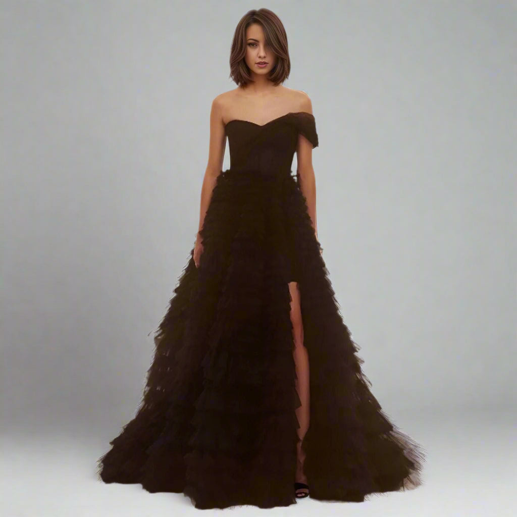 Bride wearing Velma Black Wedding Dress with tiered tulle skirt and high slit.