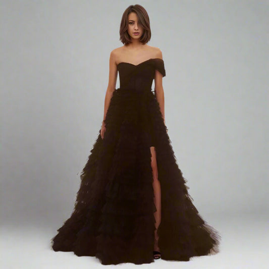 Bride wearing Velma Black Wedding Dress with tiered tulle skirt and high slit.
