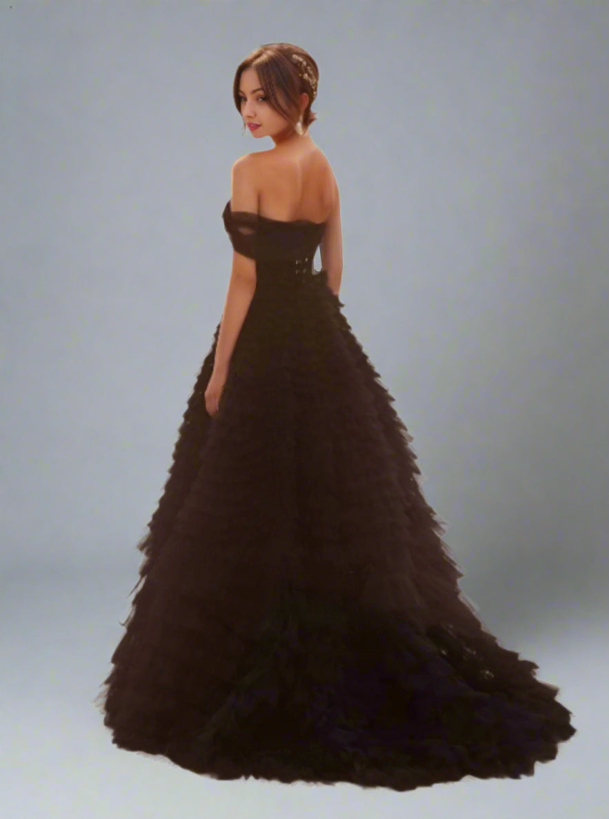 Back view of Velma black wedding dress with cascading tulle layers and one off the shoulder sleeve design.
