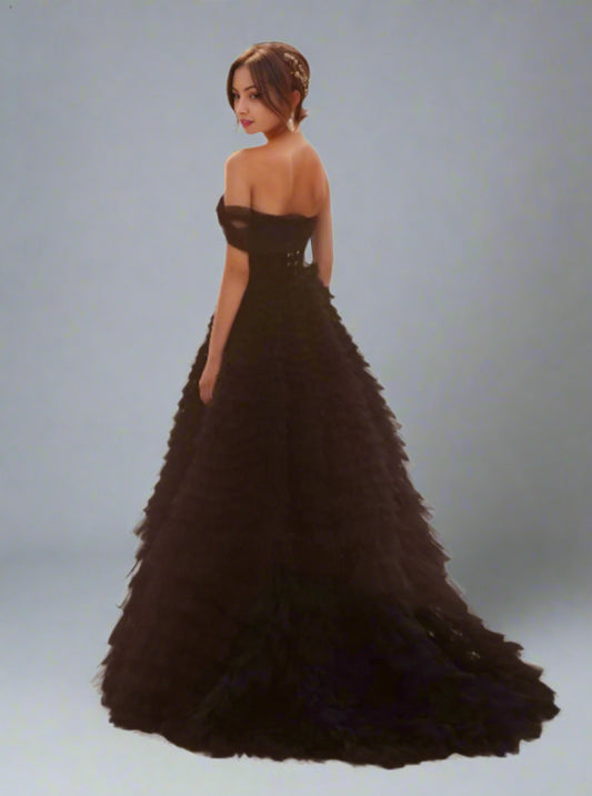 Back view of Velma black wedding dress with cascading tulle layers and one off the shoulder sleeve design.