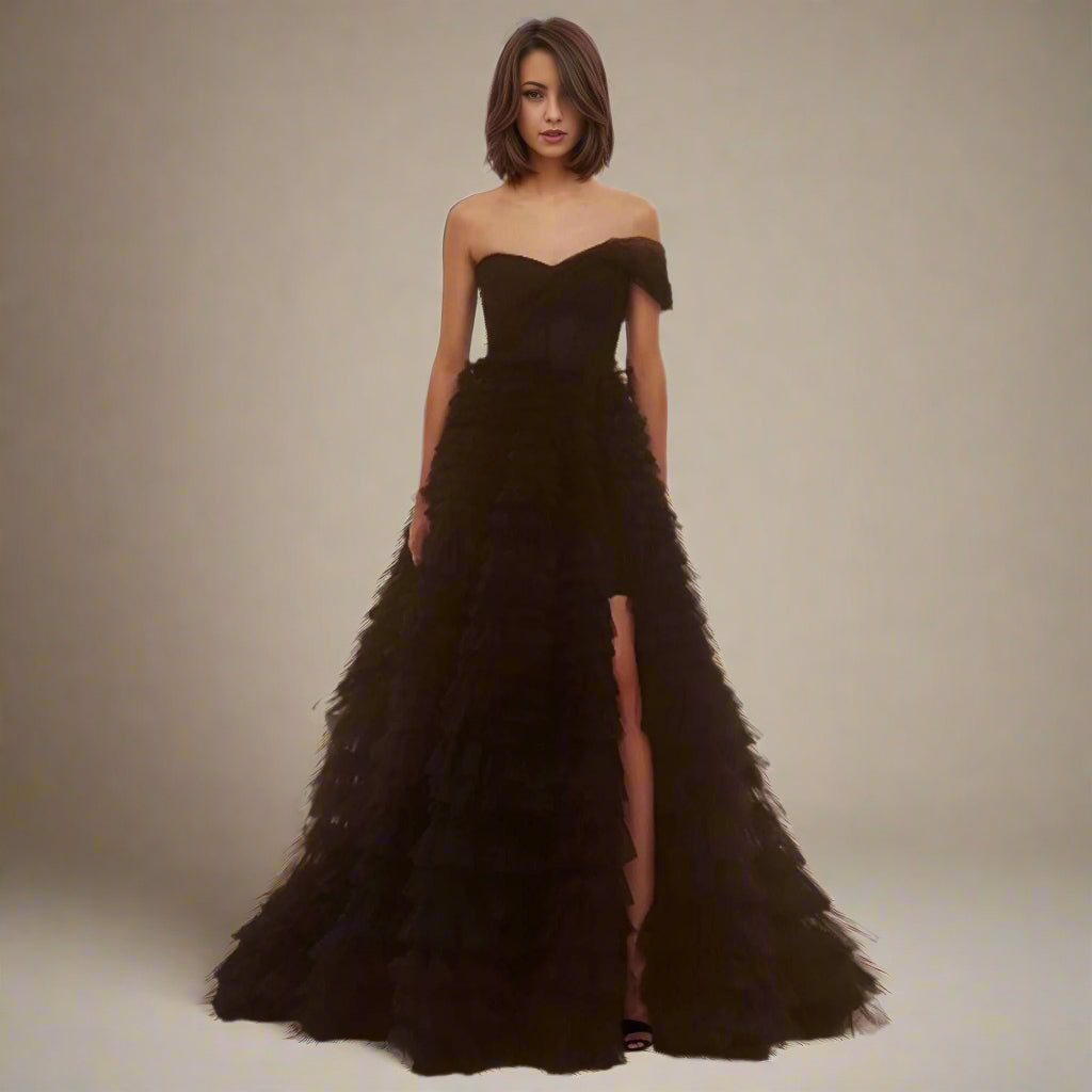 Woman wearing Velma Black Formal Dress with tiered tulle skirt.