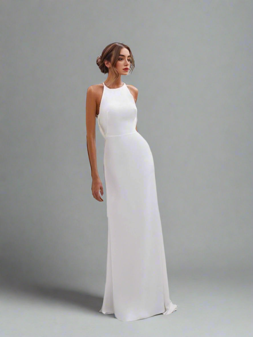 Modern halter wedding dress with a fitted trumpet silhouette.