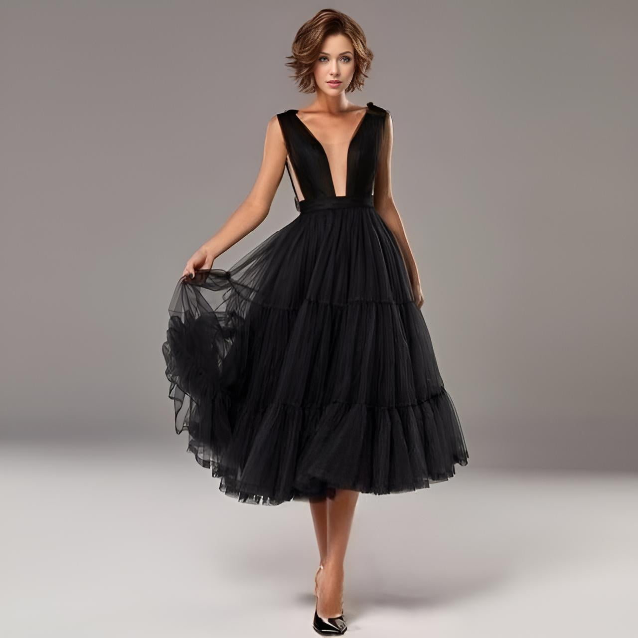 Woman wearing black Zara Formal Dress in soft tulle A-line party dress with a tiered tulle skirt.
