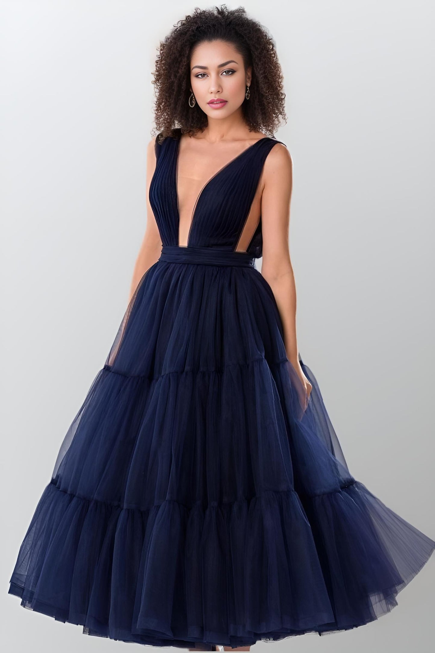 Model twirling in a sophisticated navy blue evening dress.