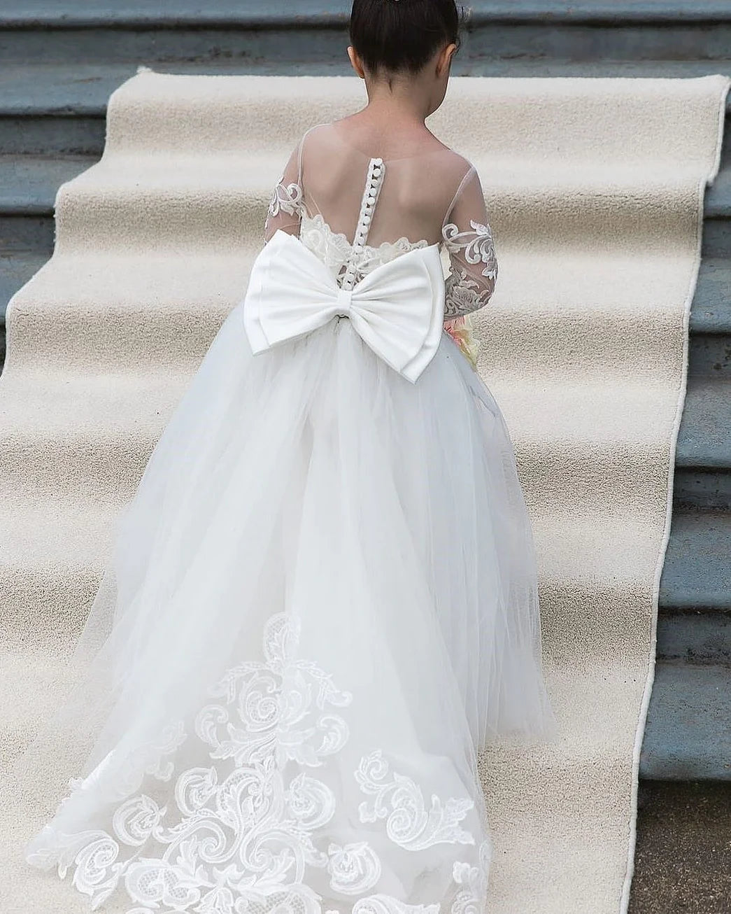 Elegant flower girl wearing MARA Dress at wedding party
