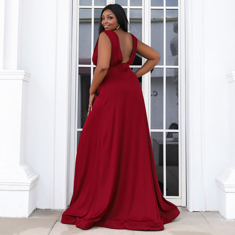 Woman in elegant formal dress in a rich burgundy color, showing her open back, designed for both plus-size and pregnant women.