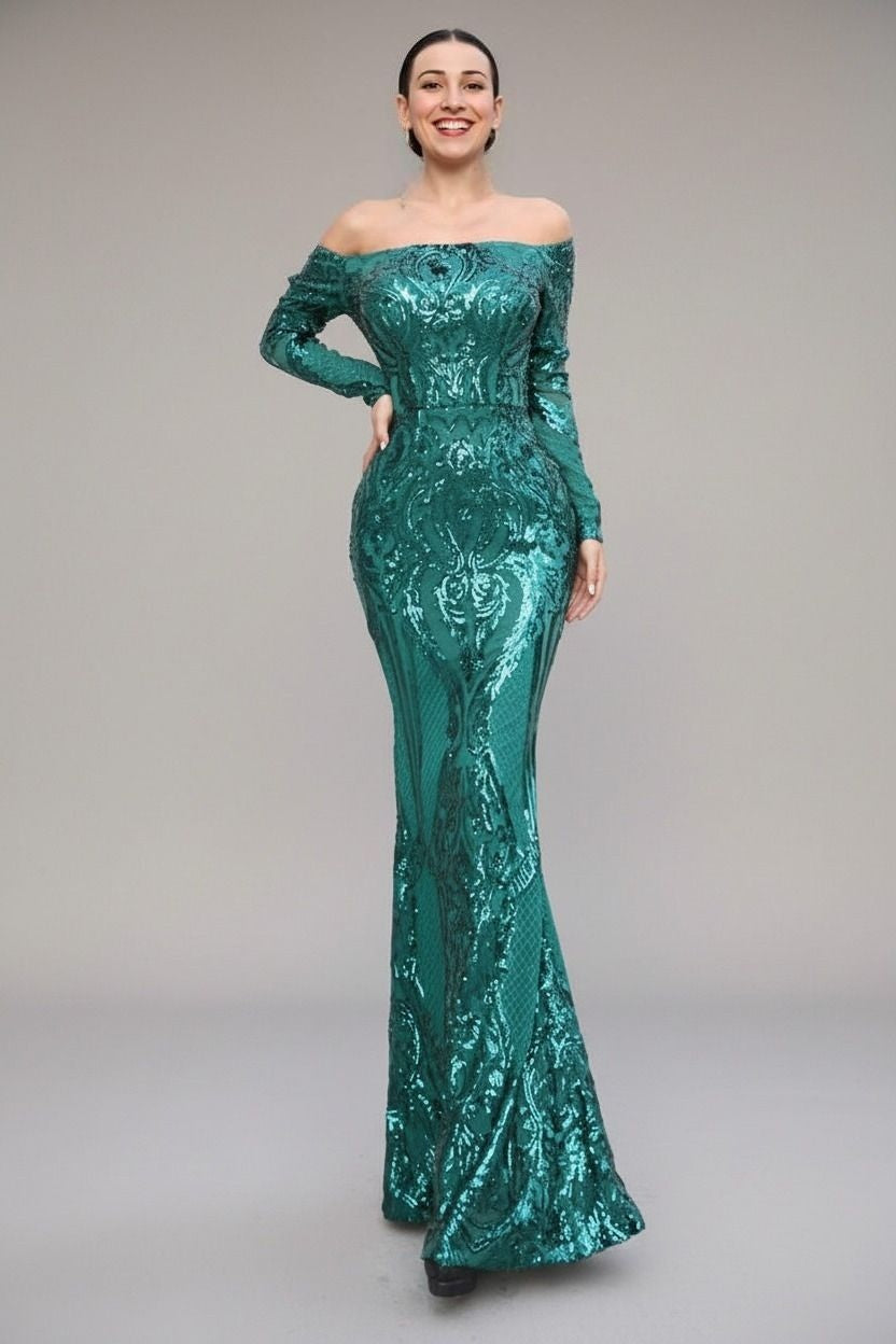 Woman wearing a teal off-shoulder sequin gown on a plain background