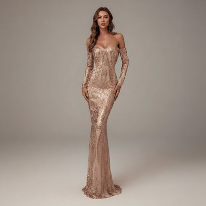 Woman wearing a long, elegant dress with a plain background