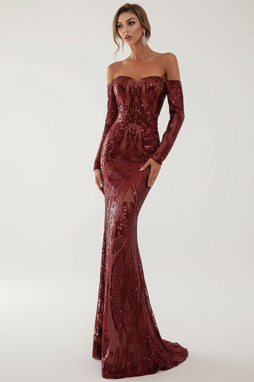 Woman wearing a burgundy sequin evening gown in an elegant indoor setting.