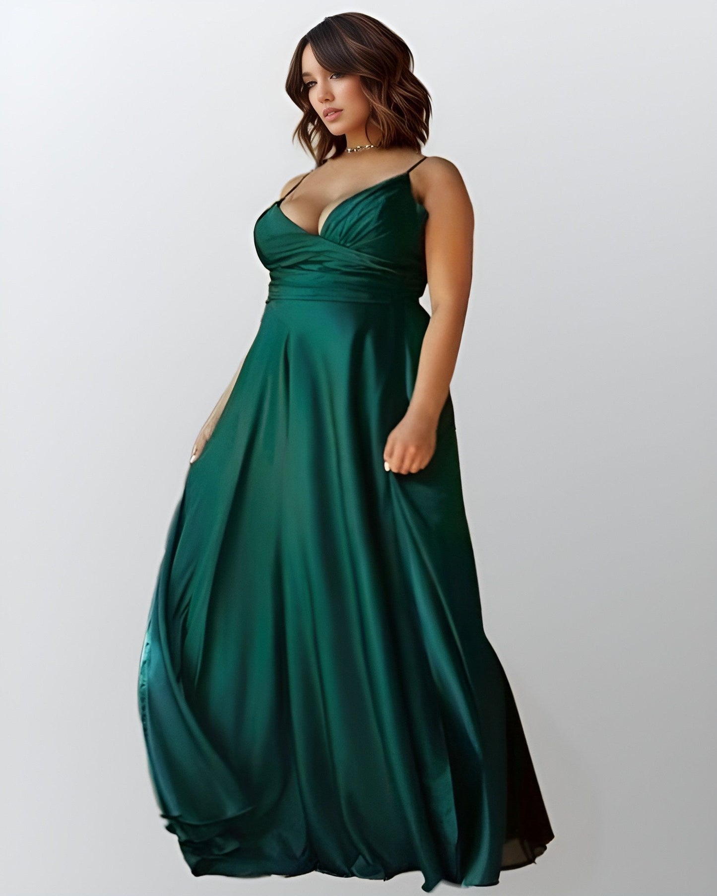 Plus size woman in flattering formal emerald green dress.