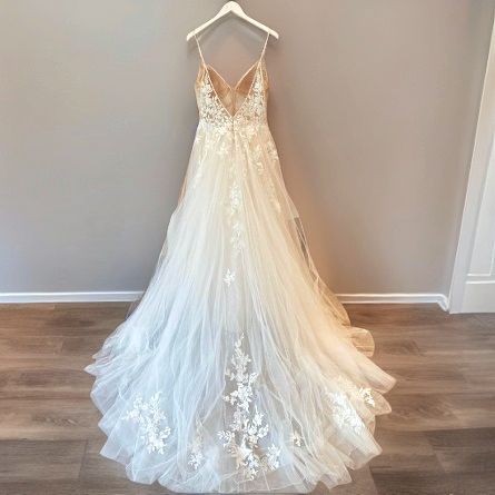 Elegant lace wedding dress with train on hanger