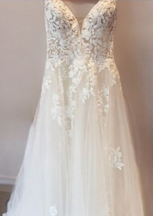 Timeless lace and tulle wedding gown hanging