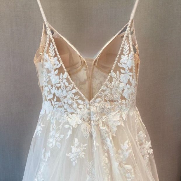 Sophisticated Backless V-neckline wedding dress on hanger